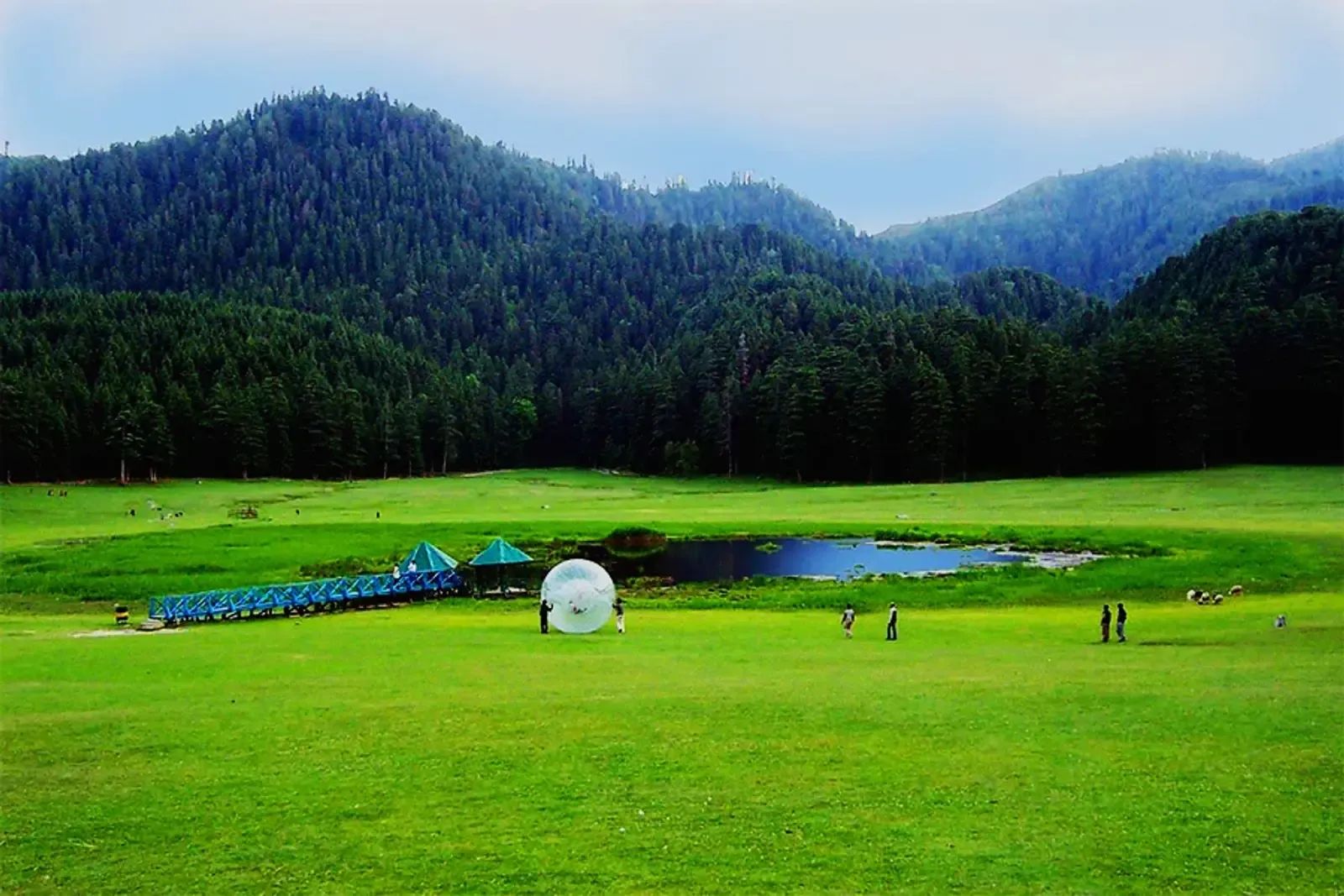 The saucer of flat grass at Khajjiar with its pond in the middle and deodar forest closing the ring all the way round.