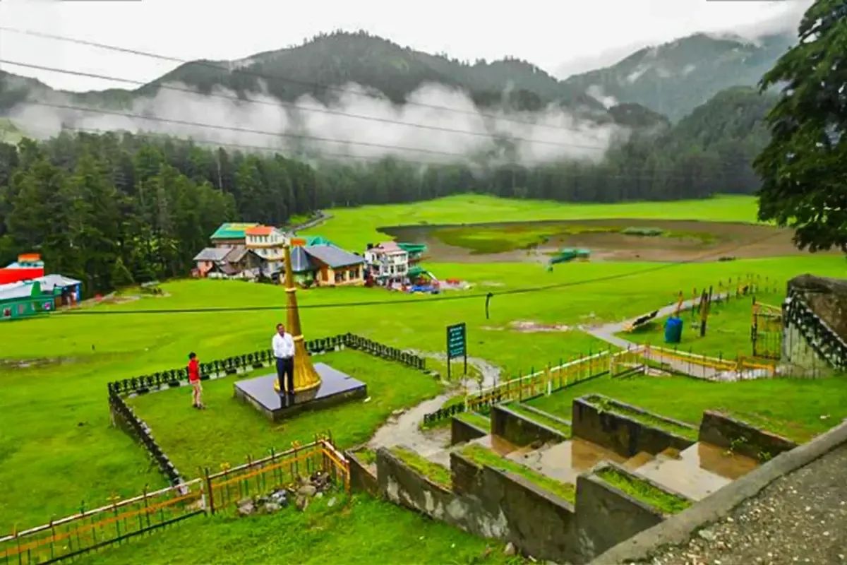 The green bowl at Khajjiar under low monsoon cloud, cedar slopes closing it in on every side.